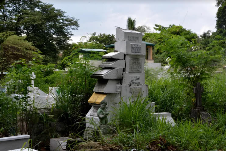 Due to the lack of space and the cost of a more decent burial, some grave markers find themselves stacked like a deck of cards. The sepultorero who tends to this particular gravestone tower says that each marker holds the actual bones of the dead that it stands to represent.(NICEFORO BALBEDINA/CBCPNEWS)